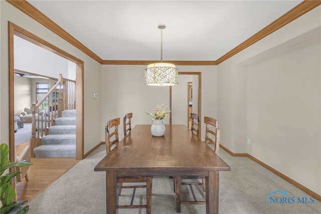 4729 Talon Trl, Maumee, OH 43537 - dining space featuring baseboards, light colored carpet, ornamental molding, and stairway