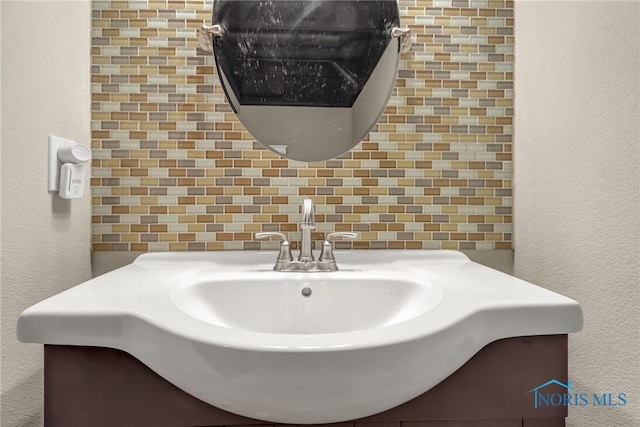 4729 Talon Trl, Maumee, OH 43537 - bathroom featuring vanity, tile walls, a textured wall, and decorative backsplash