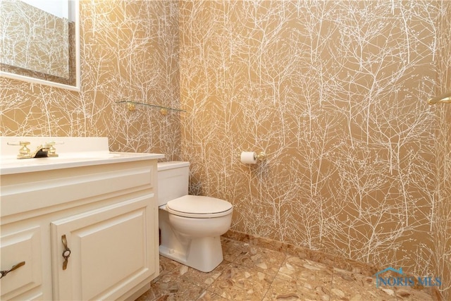 5831 Monroe St Unit 602, Sylvania, OH 43560 - half bathroom with wallpapered walls, vanity, and toilet