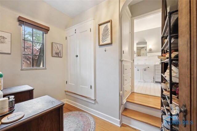 2256 Barrington Dr, Toledo, OH 43606 - home office with wood finished floors, arched walkways, baseboards, and lofted ceiling