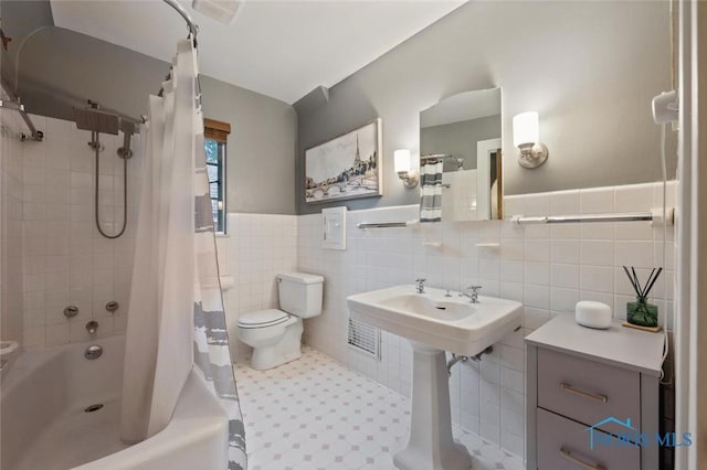 2256 Barrington Dr, Toledo, OH 43606 - bathroom with shower / bath combo, toilet, tile walls, wainscoting, and a sink