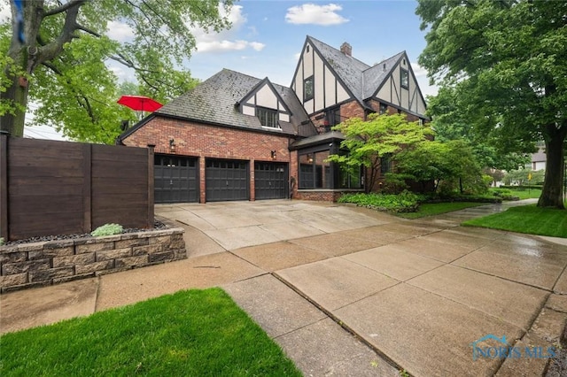 2256 Barrington Dr, Toledo, OH 43606 - view of front of house with driveway, brick siding, and an attached garage