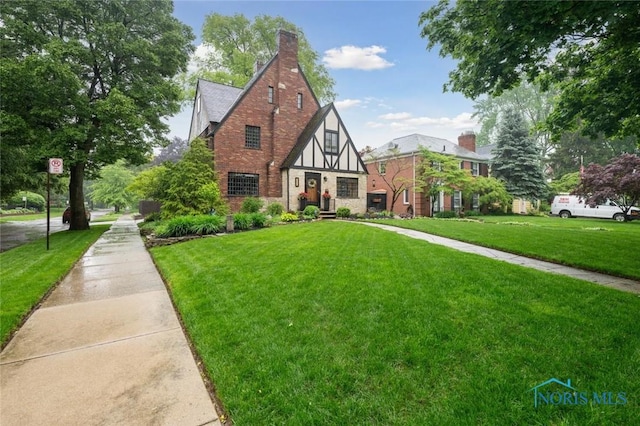 2256 Barrington Dr, Toledo, OH 43606 - english style home featuring a front yard, stone siding, and brick siding