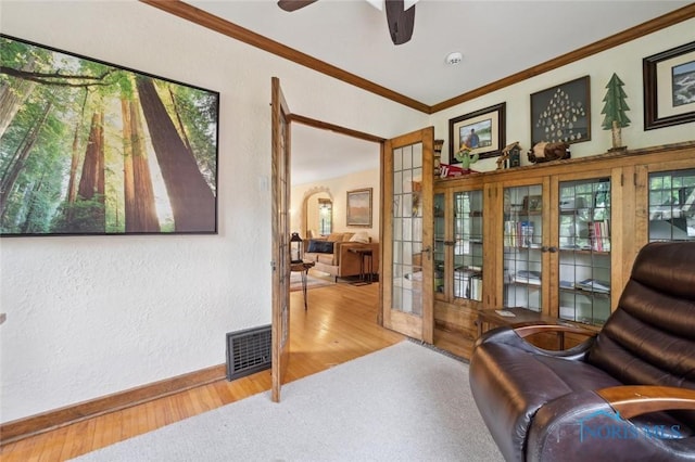 2256 Barrington Dr, Toledo, OH 43606 - living area featuring baseboards, wood finished floors, a ceiling fan, a textured wall, and ornamental molding