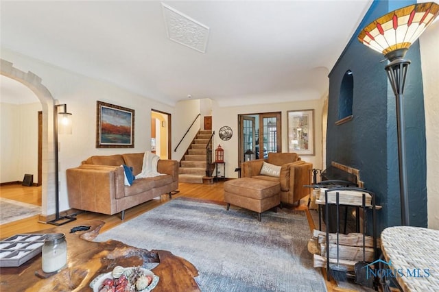 2256 Barrington Dr, Toledo, OH 43606 - living room with arched walkways, wood finished floors, stairs, and french doors