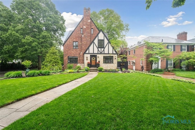 2256 Barrington Dr, Toledo, OH 43606 - english style home featuring a front lawn and a chimney