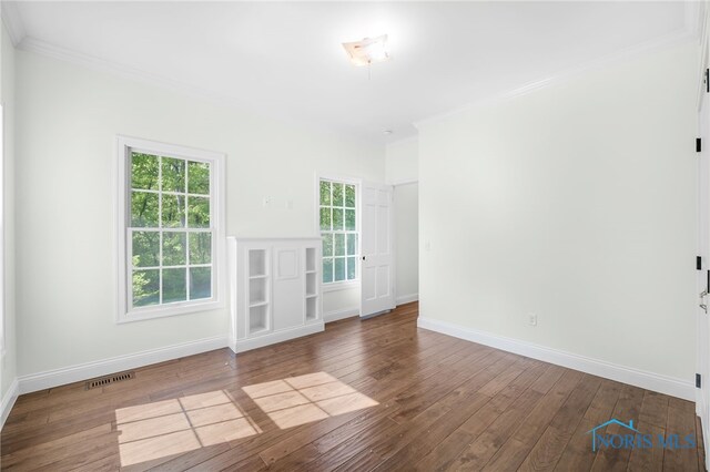 8740 Dorr St, Toledo, OH 43617 - empty room featuring hardwood / wood-style flooring, baseboards, and ornamental molding