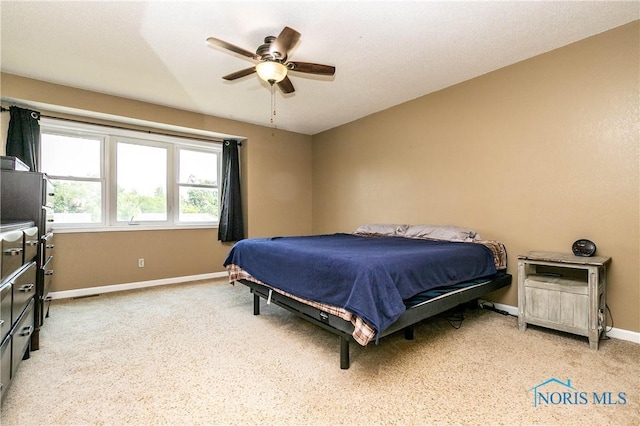 1500 S Jackson Ave, Defiance, OH 43512 - bedroom featuring baseboards, light carpet, and ceiling fan