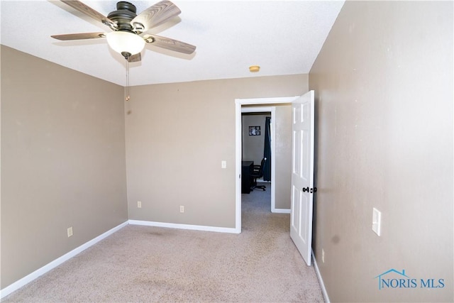 1500 S Jackson Ave, Defiance, OH 43512 - spare room with a desk, baseboards, a ceiling fan, light colored carpet, and a smoke detector