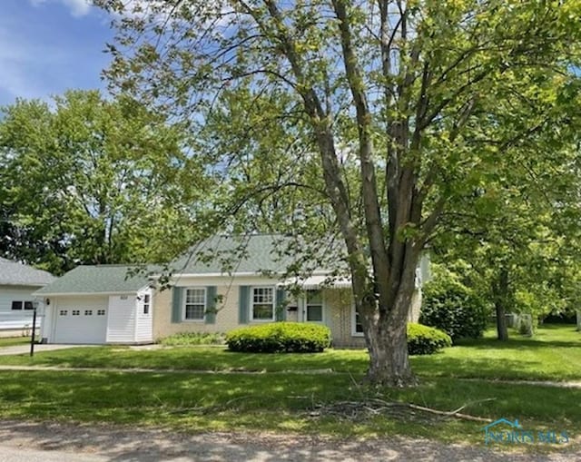 925 S Cherry St, Bryan, OH 43506 - view of front of property with an attached garage, a front lawn, and dirt driveway