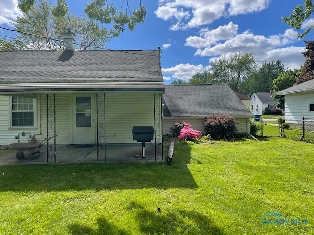 925 S Cherry St, Bryan, OH 43506 - back of property featuring a shingled roof and a chimney