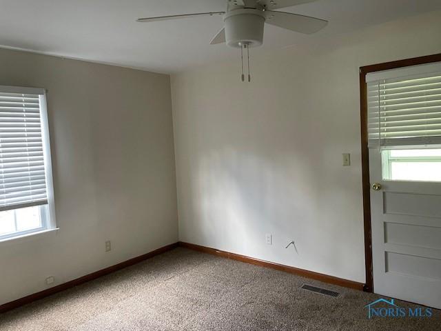 925 S Cherry St, Bryan, OH 43506 - empty room featuring plenty of natural light, a ceiling fan, carpet floors, and baseboards
