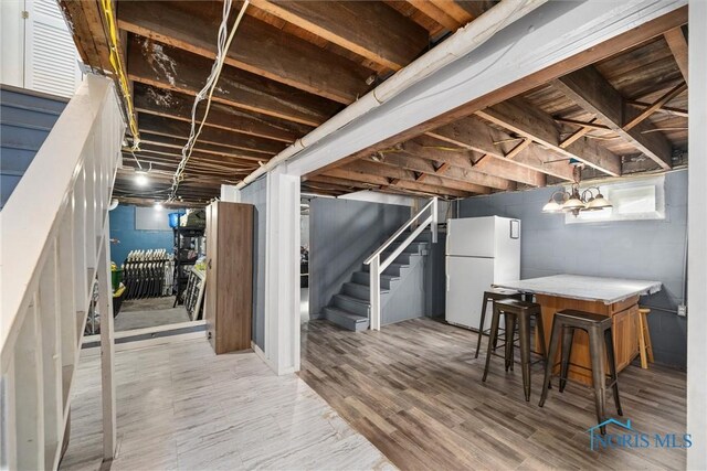 451 Toledo St, Elmore, OH 43416 - finished below grade area featuring freestanding refrigerator, stairs, and wood finished floors