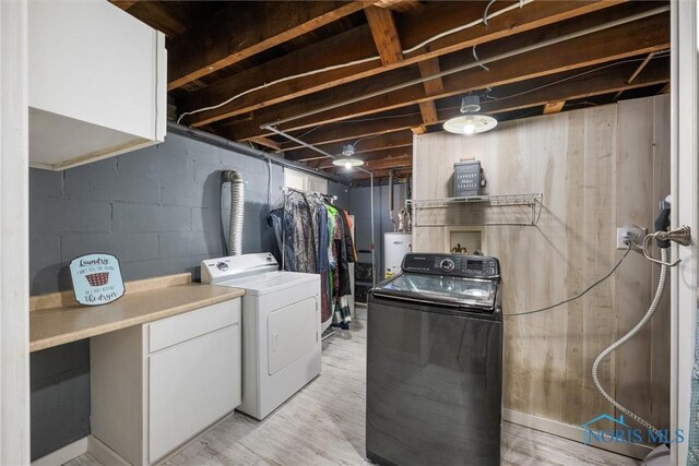 451 Toledo St, Elmore, OH 43416 - laundry room with washer and clothes dryer, water heater, and light wood-style flooring