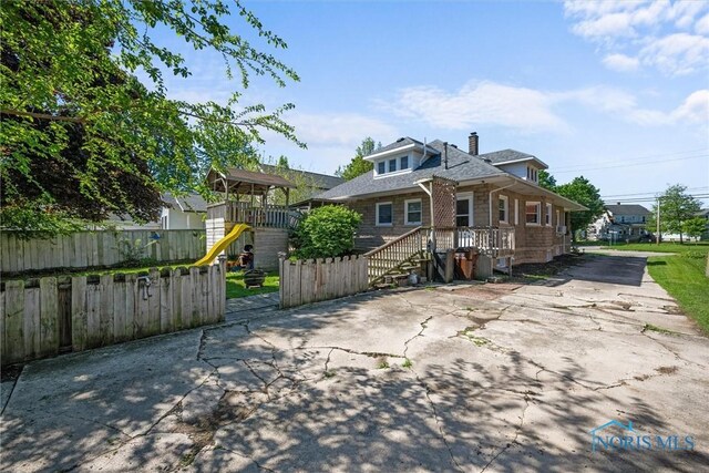 451 Toledo St, Elmore, OH 43416 - view of front of home with a playground, driveway, and a chimney