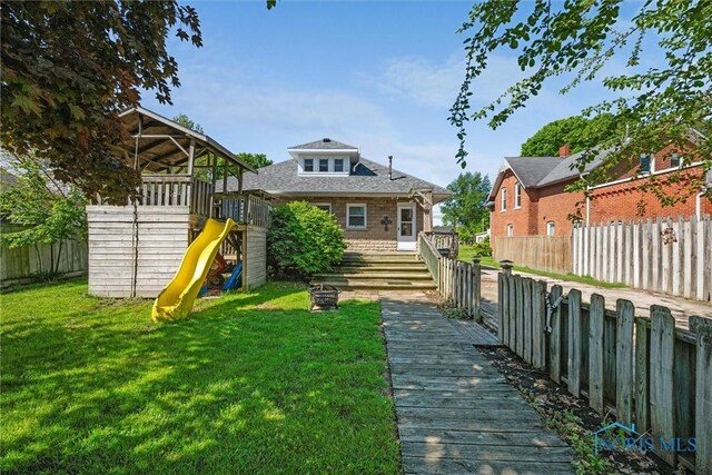 451 Toledo St, Elmore, OH 43416 - rear view of house featuring a playground and roof with shingles
