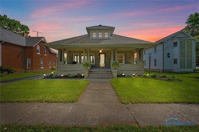 451 Toledo St, Elmore, OH 43416 - view of front of home featuring a porch, a yard, and stone siding