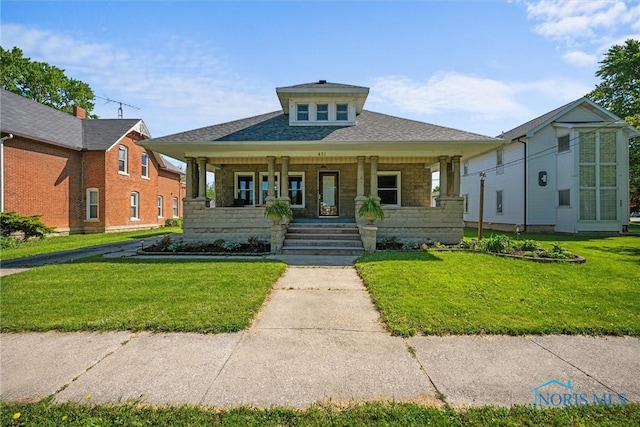 451 Toledo St, Elmore, OH 43416 - view of front of home featuring covered porch, a front yard, and roof with shingles