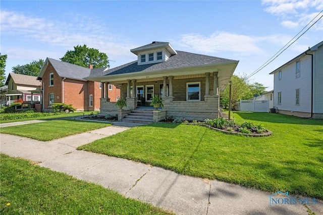 451 Toledo St, Elmore, OH 43416 - bungalow-style house featuring covered porch and a front lawn