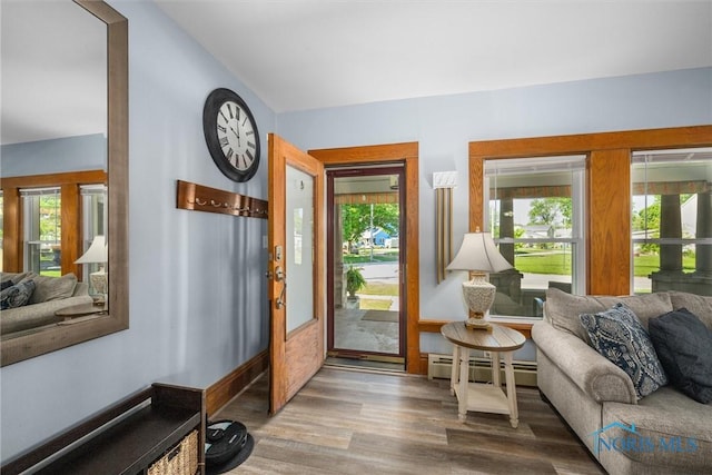 451 Toledo St, Elmore, OH 43416 - entrance foyer with baseboard heating, wood finished floors, and lofted ceiling