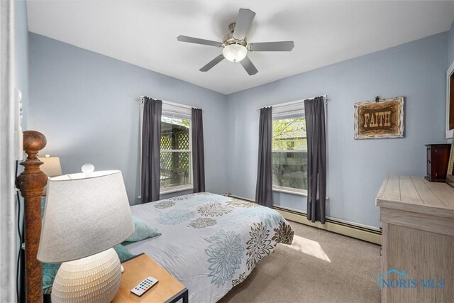 451 Toledo St, Elmore, OH 43416 - carpeted bedroom featuring baseboard heating and ceiling fan