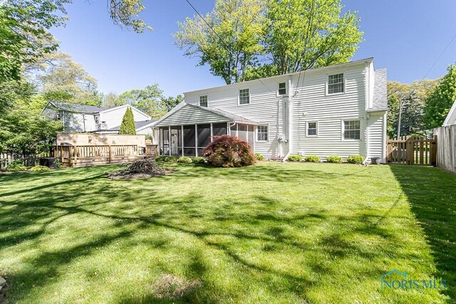 717 Birch St, Bowling Green, OH 43402 - rear view of property featuring a sunroom and a wooden deck