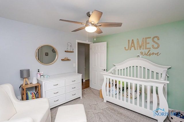 717 Birch St, Bowling Green, OH 43402 - bedroom featuring a crib, ceiling fan, and light carpet