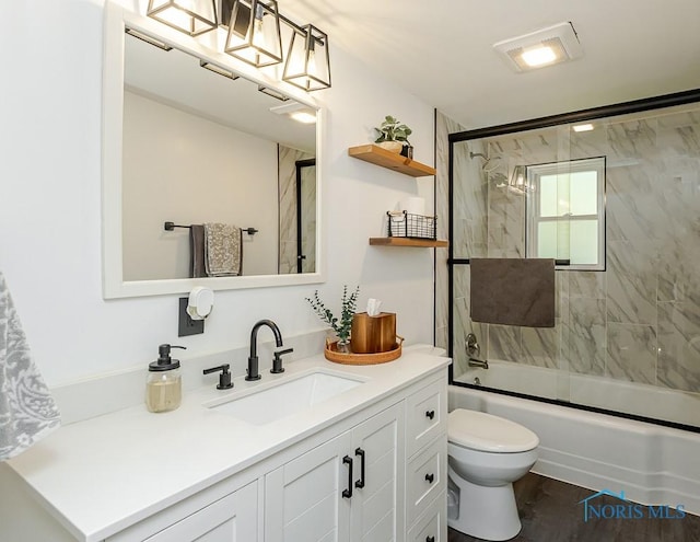 717 Birch St, Bowling Green, OH 43402 - bathroom with vanity, toilet, and bath / shower combo with glass door