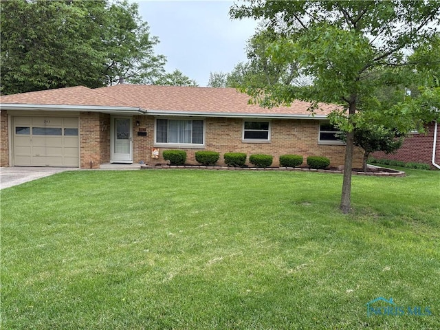 243 W S Boundary St, Perrysburg, OH 43551 - ranch-style home featuring brick siding, a front lawn, a garage, driveway, and a shingled roof