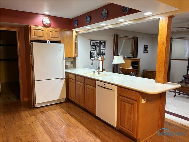243 W S Boundary St, Perrysburg, OH 43551 - kitchen featuring white appliances, a peninsula, a sink, light countertops, and light wood finished floors