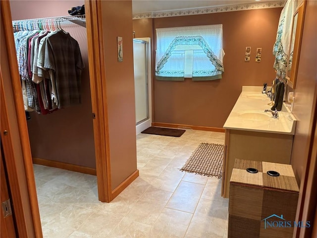 243 W S Boundary St, Perrysburg, OH 43551 - full bath featuring a spacious closet, a stall shower, double vanity, and baseboards