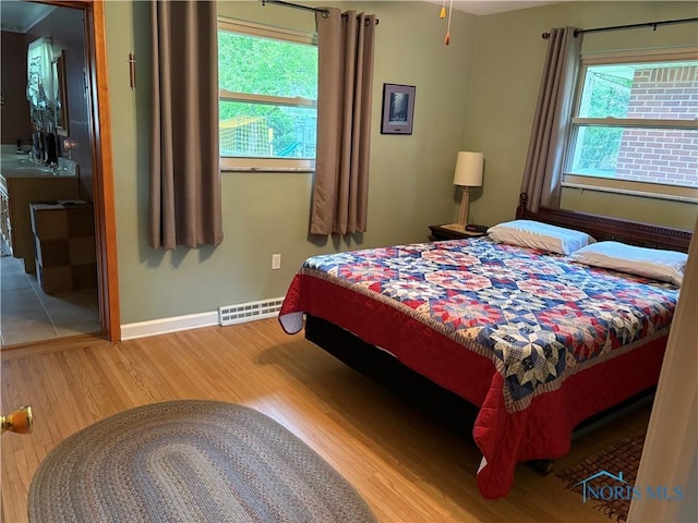 243 W S Boundary St, Perrysburg, OH 43551 - bedroom featuring wood finished floors, baseboards, and a sink