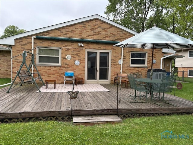 243 W S Boundary St, Perrysburg, OH 43551 - back of house featuring brick siding, a yard, outdoor dining space, and a deck