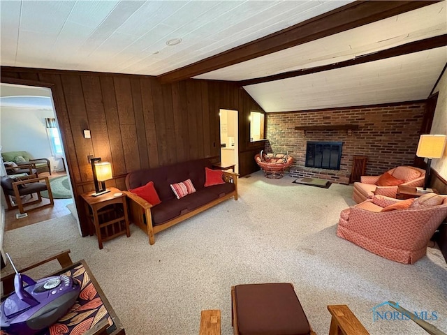 178 Gross St, Tiffin, OH 44883 - carpeted living area featuring a fireplace, wood walls, and beamed ceiling