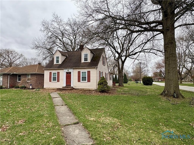 178 Gross St, Tiffin, OH 44883 - new england style home featuring a front yard and a chimney