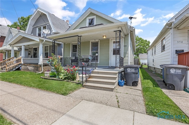 358 Burger St, Toledo, OH 43605 - view of front of house featuring covered porch, a front yard, and a gambrel roof