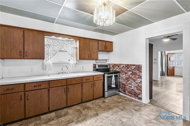 358 Burger St, Toledo, OH 43605 - kitchen featuring electric range, light countertops, a chandelier, brown cabinetry, and ceiling fan
