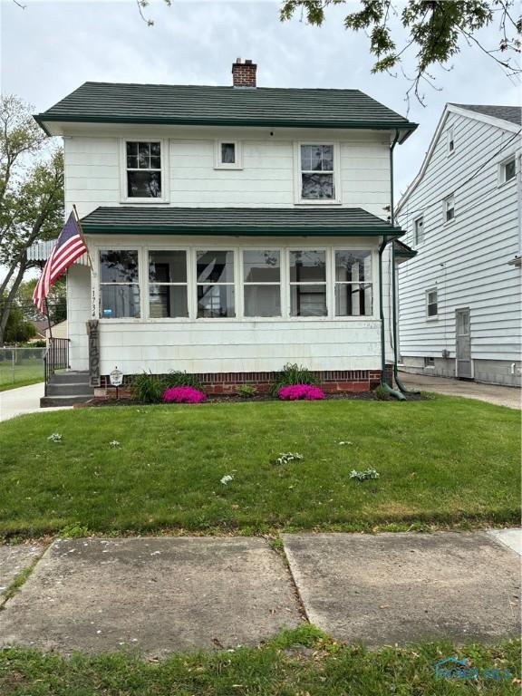 1734 Milroy St, Toledo, OH 43605 - traditional style home with a chimney and a front yard