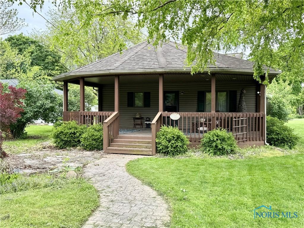 429 N Park St, Deshler, OH 43516 - view of front of house with a shingled roof and a front lawn