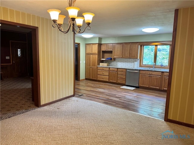 429 N Park St, Deshler, OH 43516 - kitchen with dishwasher, dark colored carpet, brown cabinetry, a chandelier, and tasteful backsplash