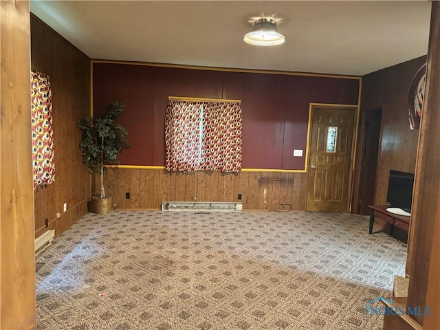 429 N Park St, Deshler, OH 43516 - carpeted foyer featuring a baseboard heating unit and wood walls
