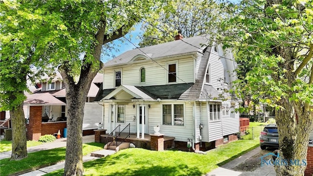 2135 Airport Hwy, Toledo, OH 43609 - view of front of house featuring a shingled roof, a front lawn, and a chimney