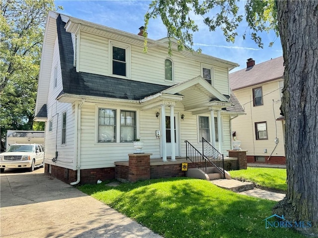 2135 Airport Hwy, Toledo, OH 43609 - colonial inspired home with a front yard, a shingled roof, and a chimney