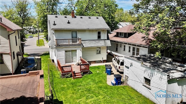2135 Airport Hwy, Toledo, OH 43609 - rear view of house with a chimney, a yard, a deck, and a balcony