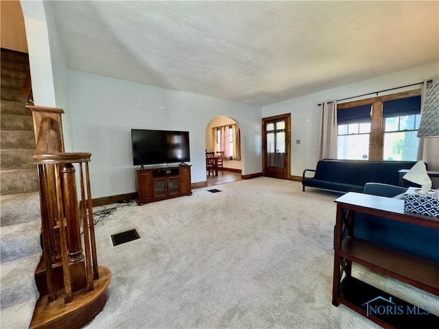 2135 Airport Hwy, Toledo, OH 43609 - living area featuring arched walkways, light colored carpet, and baseboards