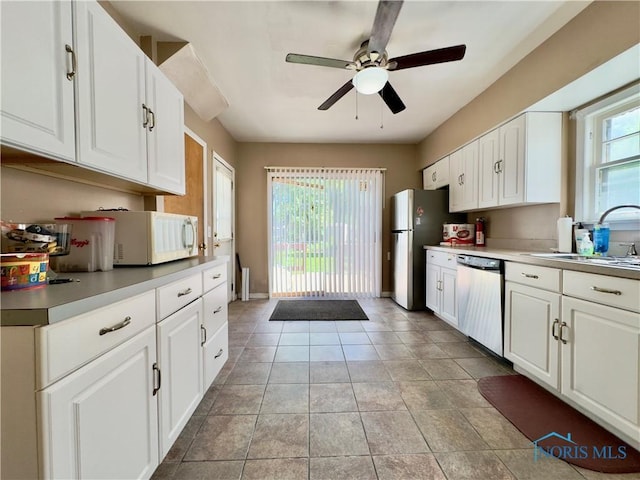 2135 Airport Hwy, Toledo, OH 43609 - kitchen featuring stainless steel appliances, a sink, ceiling fan, and white cabinets