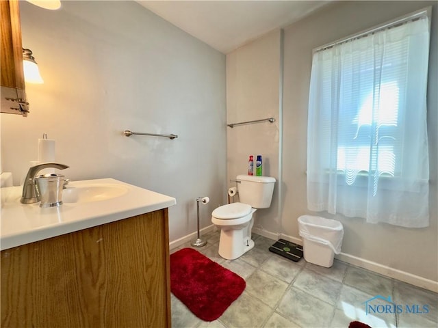 2135 Airport Hwy, Toledo, OH 43609 - half bath featuring baseboards, vanity, toilet, and tile patterned floors