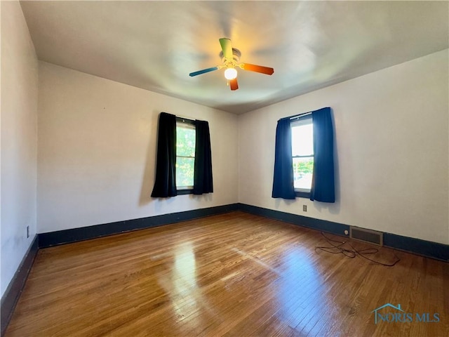 2135 Airport Hwy, Toledo, OH 43609 - empty room with wood finished floors, a ceiling fan, and baseboards