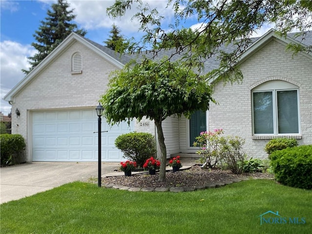 2456 Plum Leaf Ln, Toledo, OH 43614 - ranch-style home featuring brick siding, concrete driveway, a front lawn, and an attached garage