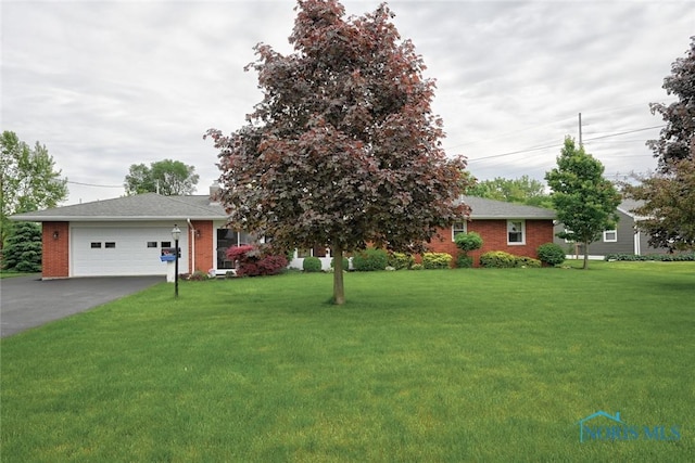 2534 Blanchard Ave, Findlay, OH 45840 - ranch-style home with a front lawn, asphalt driveway, brick siding, and a garage